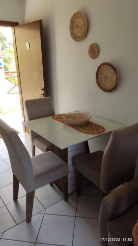 a dining room table with chairs and a table and a table and chairs at CONDOMÍNIO VILA DO MAR in Aquiraz