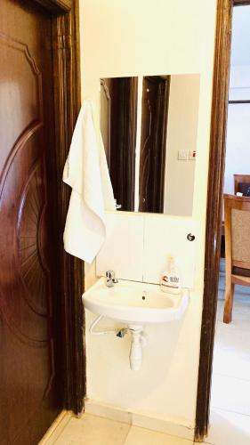 a bathroom with a sink and a mirror at Gem in Busia