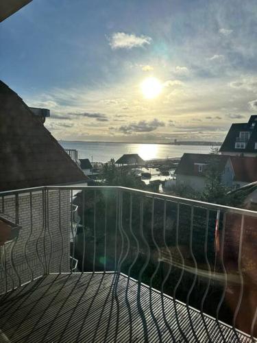 a balcony with a view of the ocean and the sun at ٤Neu٤Fantastischer Meerblick-Stylish-King Bed-PP in Scharbeutz