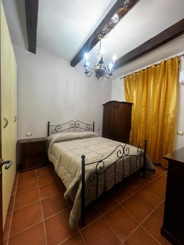 a bedroom with a bed and a chandelier at LA CASA CHE VORREI in Crotone