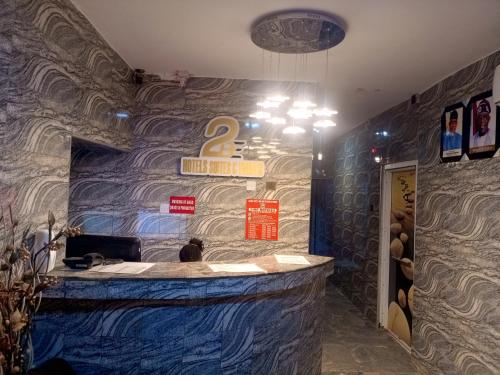 a bar in a restaurant with a blue wall at 2BE HOTELS SUITES AND EVENTS 