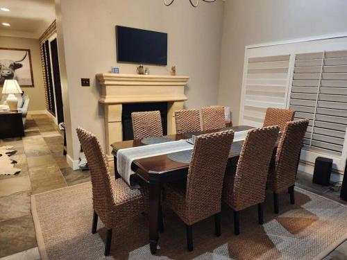 a dining room with a table and chairs and a fireplace at Family Tides! Lake Gladewater in Gladewater
