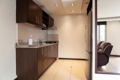 a kitchen with a sink and a counter top at Olympus Apartments in Quito