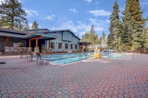 a house with a swimming pool next to a building at Slope Side Studio in Northstar Village! in Truckee