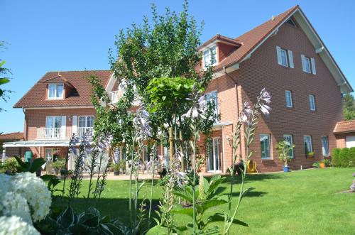 a large house with a garden in front of it at Hotel Flora in Herzlake