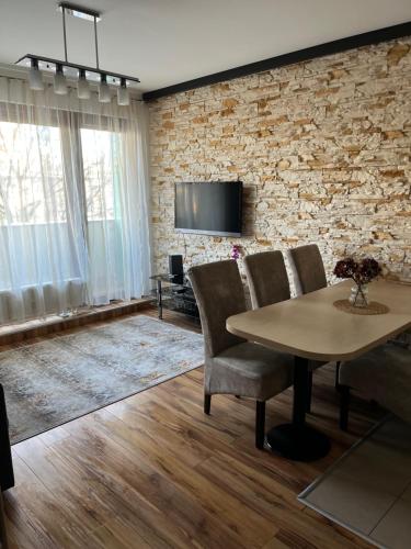 ブダペストにあるDanube Terrace Apartmentの石壁のリビングルーム(テーブル、椅子付)