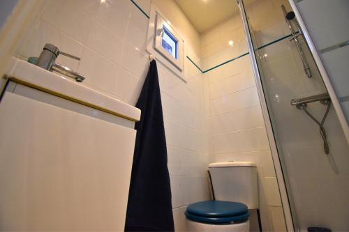 a bathroom with a shower and a toilet and a sink at Tour Pleyel - Duplex Lumineux in Saint-Denis