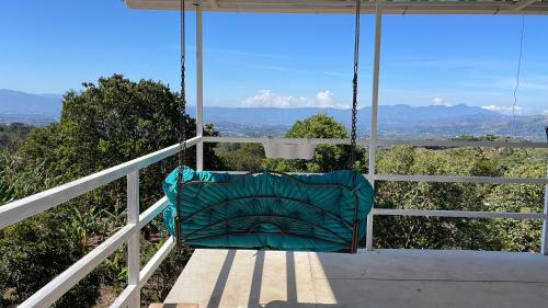 a swing on a porch with a view of the mountains at Cabaña mirador Jacuzzi in Robles