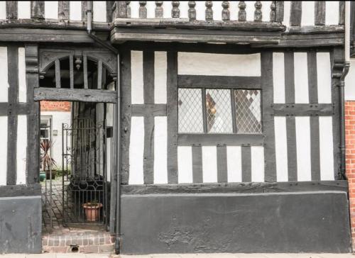 a black and white building with a door and window at Little Libertys in Shrewsbury