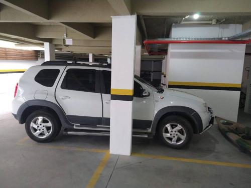 una camioneta blanca estacionada en un garaje en Apartamento 401 Palmas Beach, en Governador Celso Ramos