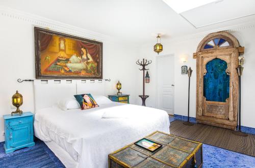 Säng eller sängar i ett rum på L'Hôme du Monde