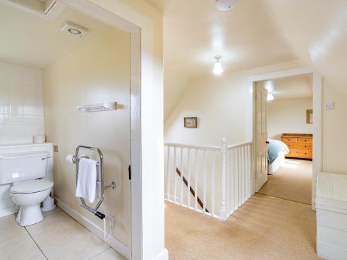 a bathroom with a toilet and a bedroom at 3 bed in Carron CA227 in Carron