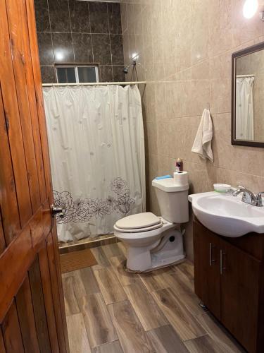 a bathroom with a toilet and a sink at Finca Campestre Los Pinos in Arteaga