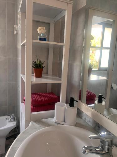 a bathroom with a sink and a mirror at Apartamento La Ermita in Chulilla