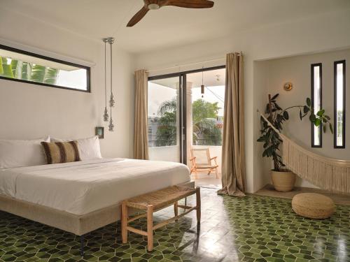 a bedroom with a large bed and a patio at CASA FRIDA by DW in San Juan