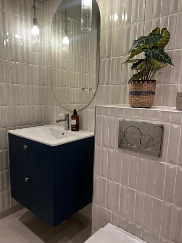 a bathroom with a sink and a mirror at Svea Deluxe Apartment in Stockholm