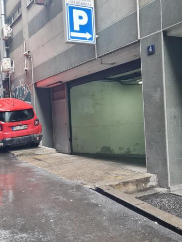 a parking garage with a red car parked in it at Centrum in Belgrade