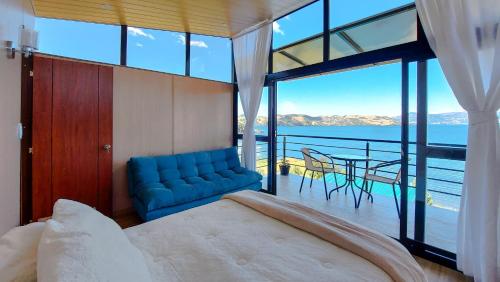 托塔的住宿－Cabañas los Sauces，一间卧室配有蓝色的沙发和餐桌
