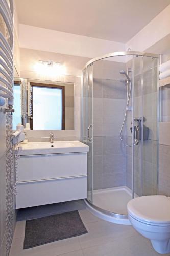 a bathroom with a shower and a sink and a toilet at Willa Widokówka Lubawka in Lubawka