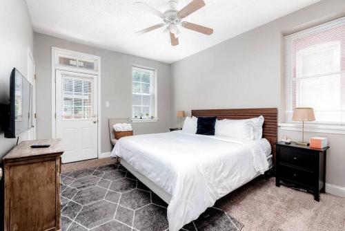 a bedroom with a white bed and a ceiling fan at 3 King Beds/3Baths Spacious in Soulard