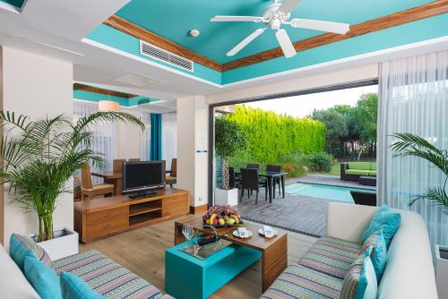 a living room with a blue ceiling at Lykia World Links Golf Antalya in Denizyaka