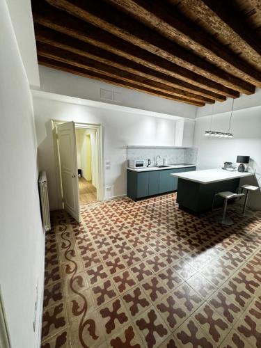 a large kitchen with a table and a counter at SAN LORENZO APARTMENTS 5054 in Venice