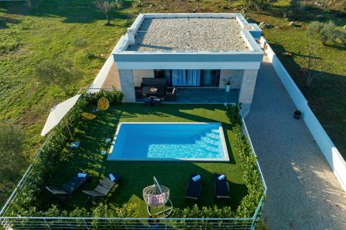 an overhead view of a house with a swimming pool at Orchid Stay in Dobropoljana