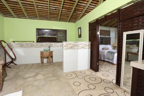 a room with a bedroom with a bed and a desk at Strawberry Fields Together in Robins Bay