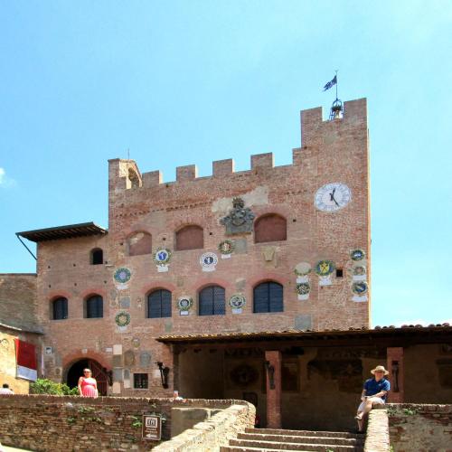 a large brick building with a clock on it at Podere Ghiole in Montespertoli
