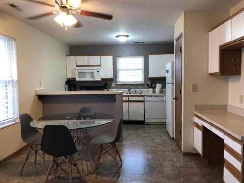 a kitchen with a table and chairs in a room at 2 bedroom apartment RivianISU in Bloomington