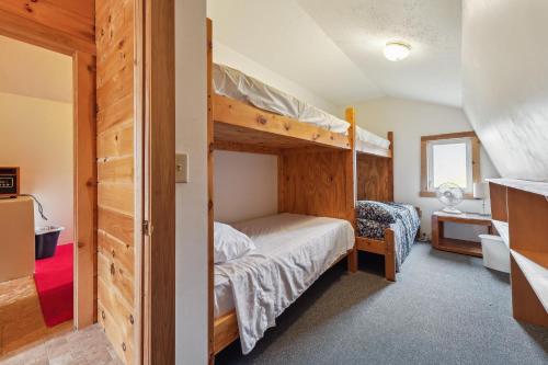 a bedroom with two bunk beds in a room at Canaseraga Malarkey Home - 5 Mi to Skiing! 