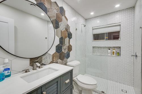 a bathroom with a sink toilet and a mirror at Stunning Jackson Home about 2 Mi to Downtown! in Jackson