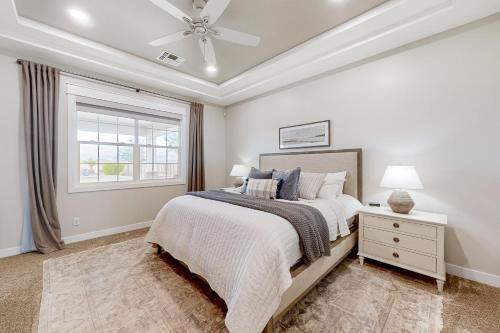 a bedroom with a bed and a ceiling fan at Queen Creek Oasis in Queen Creek