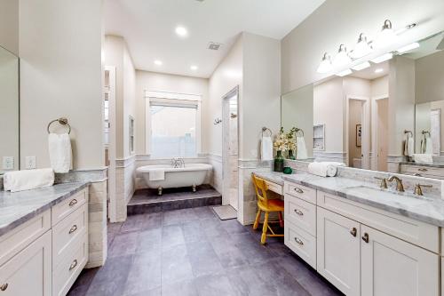 a bathroom with two sinks and a bath tub at Queen Creek Oasis in Queen Creek