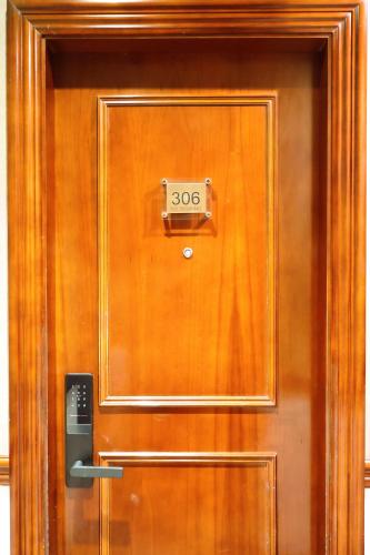 a wooden door with a sign on it at Dreamtel London Kensington in London