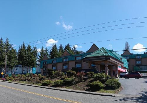 a building on the side of a street at Sutton Suites Hotel in SeaTac
