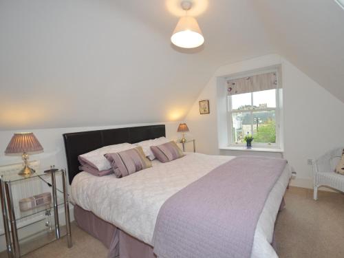 a bedroom with a large bed and a window at 2 bed in Huntly AB171 in Huntly