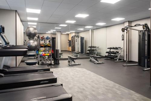a gym with treadmills and machines in a room at Courtyard by Marriott Seattle SeaTac Airport in Seattle