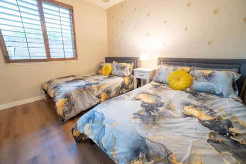 a bedroom with two beds and a window at Ping Pong, A/C, Netflix, Grill, Jacuzzi Tub, W/D in Placentia