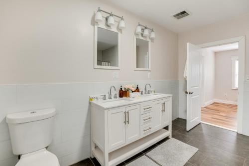Baño blanco con aseo y lavamanos en Spacious East Orange Home Steps to Elmwood Park!, en East Orange