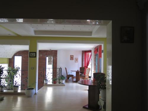 a living room with a table and a dining room at Hotel Lido in Durrës