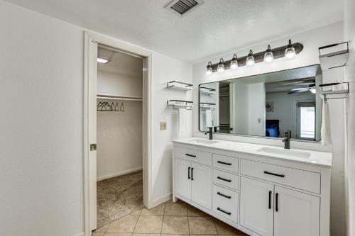 a bathroom with two sinks and a large mirror at 8 Mi to State Farm Stadium Home with Pool in Peoria