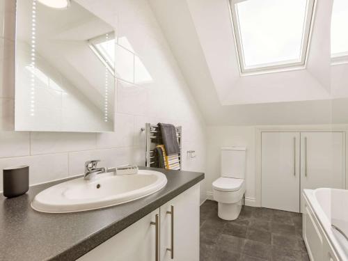 a white bathroom with a sink and a toilet at 1 Bed in Polyphant 89860 in Trewen