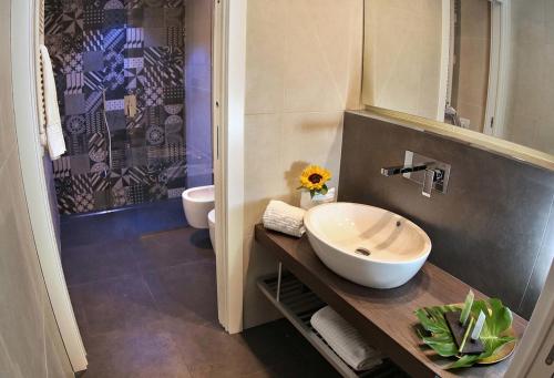 a bathroom with a sink and a shower at Principe Relais Suite & Spa in Gravina in Puglia