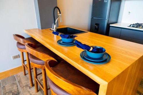 a kitchen with a wooden table with two dishes on it at Montecielo Hosting in Guatapé
