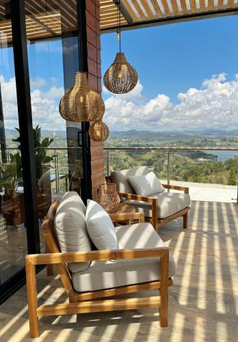 a balcony with a view of the water at Montecielo Hosting in Guatapé