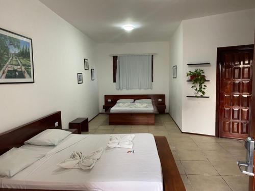 a bedroom with two beds in a room at Hotel Pousada Canoa Quebrada in Canoa Quebrada