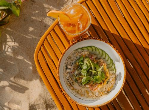 a plate of food on a table with a bowl of food at Guaycura Boutique Hotel, Beach Club & Spa in Todos Santos