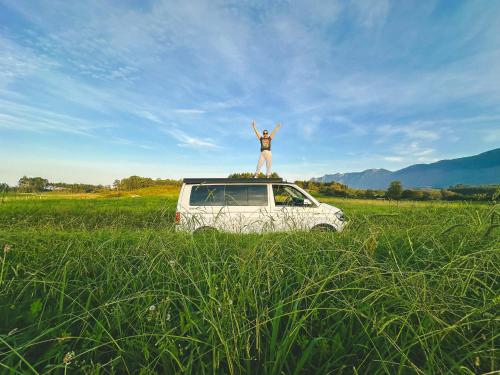 a person standing on top of a van in a field at Live On The Horizon 2 in Ribadesella