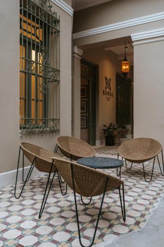 a group of tables and chairs on a floor at Kahal Hotel - Paseo Montejo in Mérida